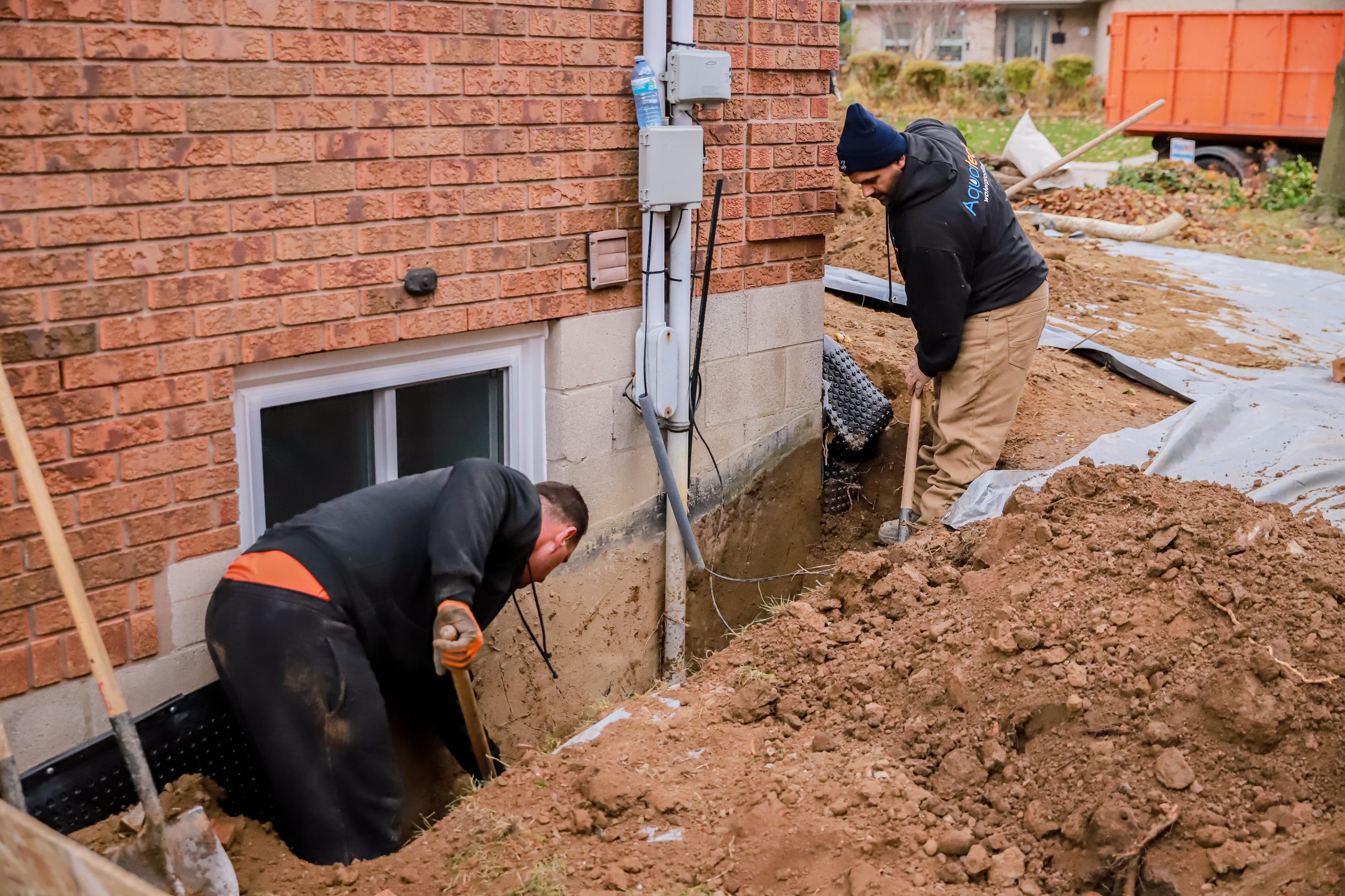 Aquatech Waterproofing workers excavating trench for foundation waterproofing